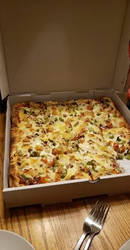 Loaded deep dish pizza with premium ingredients in Calgary NW