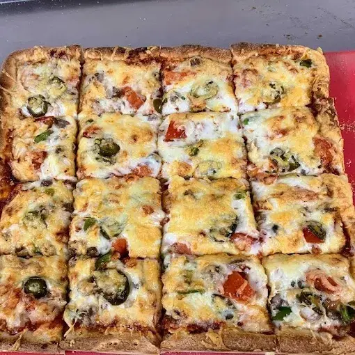 Square deep dish pizza with fresh toppings in Calgary